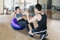 Personal trainer helping young woman doing workout Royalty Free Stock Photo