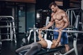 Personal trainer helping a young woman lift a barbell while working out in a gym Royalty Free Stock Photo