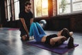 Personal trainer helps a girl with the gym exercises Royalty Free Stock Photo