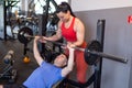 Personal trainer helps to weak client doing bench press Royalty Free Stock Photo