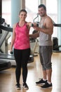 Gym Coach Helping Woman On Shoulder Exercise Royalty Free Stock Photo