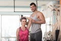 Gym Coach Helping Woman On Triceps Exercise Royalty Free Stock Photo