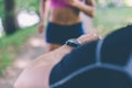 Personal trainer timing a female runner. Selective focus. Royalty Free Stock Photo