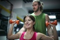 Personal trainer training his client in the gym. Royalty Free Stock Photo