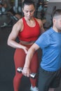 Personal trainer woman holding clients elbow during workout concept Royalty Free Stock Photo