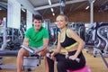 Personal trainer and a woman relaxing in the gym after exercise