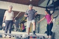 Personal trainer working exercise with senior couple.
