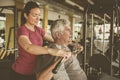 Personal trainer working exercise with senior man in the gym. Pe Royalty Free Stock Photo