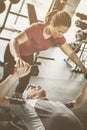 Trainer working exercise with senior man in the gym. Ma Royalty Free Stock Photo