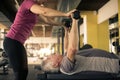 Trainer working exercise with senior man in the gym. Ma Royalty Free Stock Photo