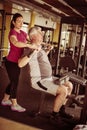 Personal trainer working exercise with senior man in the gym. Royalty Free Stock Photo