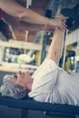 Personal trainer working exercise with senior woman in the gym. Royalty Free Stock Photo