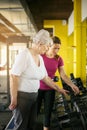 Trainer working exercise with senior woman in the gym. Royalty Free Stock Photo
