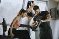 Personal trainer with young woman on cycling machine at the gym Royalty Free Stock Photo