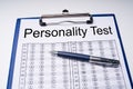 Personality Test Sheet And Pen With Clipboard Over Table
