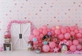 Personalized romantic decor with colorful spring flower pots, barn door, colorful balloons for first birthday