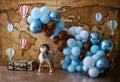 Personalized romantic decoration with colorful balloon arch, bear aviator and lights for first birthday