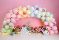 Personalized romantic garden decoration with colorful balloon arch, with flowers and lights for 1st birthday