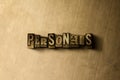 PERSONALS - close-up of grungy vintage typeset word on metal backdrop
