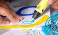 A persone drawing 3d pen that hardens in the air close-up. Royalty Free Stock Photo