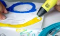 A persone drawing 3d pen that hardens in the air close-up.