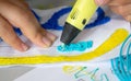 A persone drawing 3d pen that hardens in the air close-up. Royalty Free Stock Photo