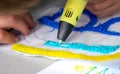 A persone drawing 3d pen that hardens in the air close-up. Royalty Free Stock Photo