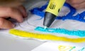 A persone drawing 3d pen that hardens in the air close-up.