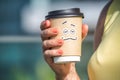 Personified take away coffee cup in woman hand Royalty Free Stock Photo