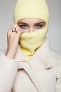 Personl in yellow balaclava. Trendy Mask on pretty woman