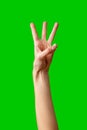 Human Hand Displaying the Number Three Against a Solid Green Background Royalty Free Stock Photo