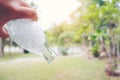 Persons hand holding a bottle of water cool ice poring it out in Royalty Free Stock Photo