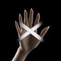a persons hand is holding an x sign in front of a black background