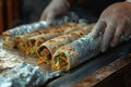 A persons hand securely holds a delicious burrito wrapped in tin foil