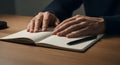 Close-up of Hands Reading Braille Book on Wooden Table Royalty Free Stock Photo