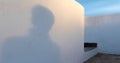 Persons shadow on a white wall with step