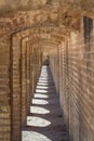 Perspective of the ancient stone arches of the Si o Seh Pol bridge on the afternoon in Isfahan, Iran. Royalty Free Stock Photo