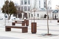 Perspective of a city street. Wooden modern benches parallel to each other Royalty Free Stock Photo
