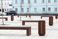 Perspective of a city street. Wooden modern benches parallel to each other Royalty Free Stock Photo