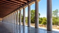 Perspective of classical building columns in ancient Agora, Athens, Greece. Panoramic view inside the Stoa of Attalos Royalty Free Stock Photo