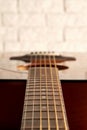 Perspective close up view of an acoustic guitar neck and strings Royalty Free Stock Photo