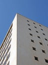 Perspective corner view of an old white 1960s concrete office block against a blue sky Royalty Free Stock Photo