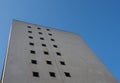 Perspective corner view of an old white 1960s concrete office block against a blue sky Royalty Free Stock Photo