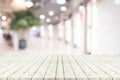 Perspective empty white wooden table over blurred shopping mall Royalty Free Stock Photo