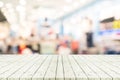 Perspective empty white wooden table over blurred shopping mall Royalty Free Stock Photo