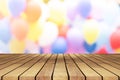 Perspective empty white wooden table on top over blur balloon background, can be used mock up for montage products display or Royalty Free Stock Photo