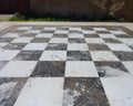 Perspective image of floor with black and white tiles. Chess board made of stone. Old picture Royalty Free Stock Photo