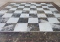Perspective image of floor with black and white tiles. Chess board made of stone. Old picture Royalty Free Stock Photo
