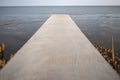 Perspective long cement bridge extends to the sea with natural s Royalty Free Stock Photo