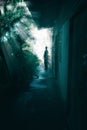 Perspective of man on the end of way in darkness with retro abandoned house